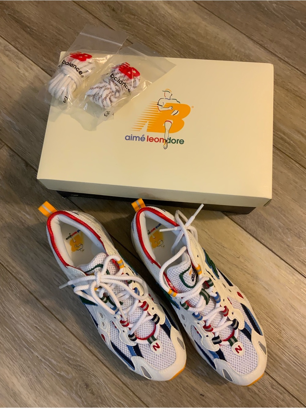 New Balance Kids White Sneakers with Red, Blue, Green & Yellow Accents